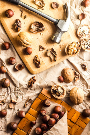 Walnuts and hazelnuts are on the table. Whole and broken nutshells lie on a backgroundの写真素材