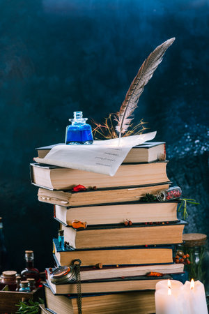 a tall stack of books on which a scroll lies on top, on which there is an inkwell and a pheasant pen from which sparks flyの写真素材