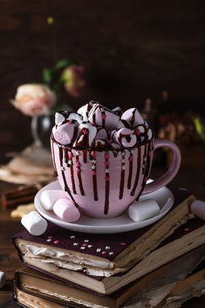 A mug of hot cocoa, full of marshmallows and sprinkled with chocolate on topの写真素材