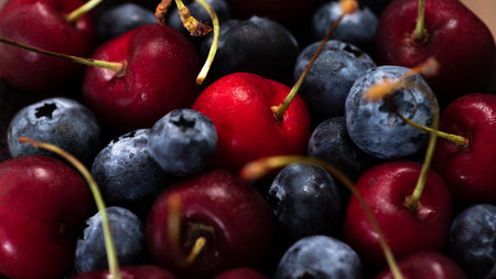 cherries and blueberries mixed together. berry background.
