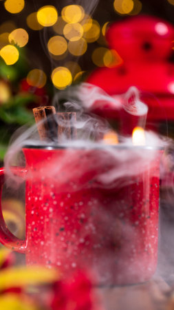 Mulled wine in a red mug on the autumn table