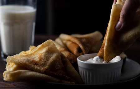 pancakes rolled up into tubes lie on a slideの写真素材