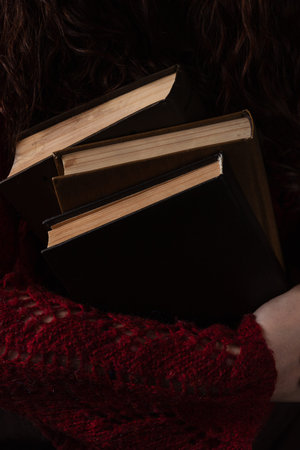 A book with a flower as a bookmark in the hands of the reader