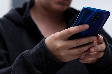 A smartphone in the hands of a girl