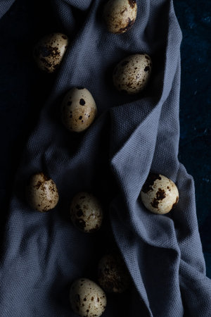 Chicken eggs in a wicker basket and on a towel