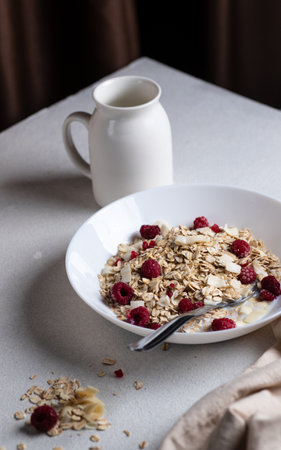Oatmeal in a bowl with berries and coconut chipsの写真素材