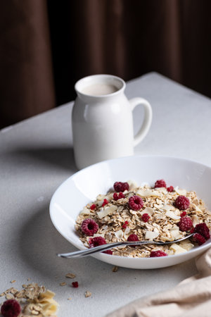 Oatmeal in a bowl with berries and coconut chipsの写真素材