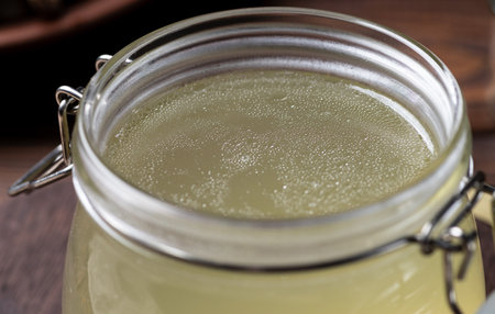 bone broth in a storage jar with herbsの写真素材