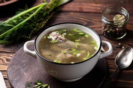 Chicken soup with dill and meat in a bowl on wooden backgroundの写真素材