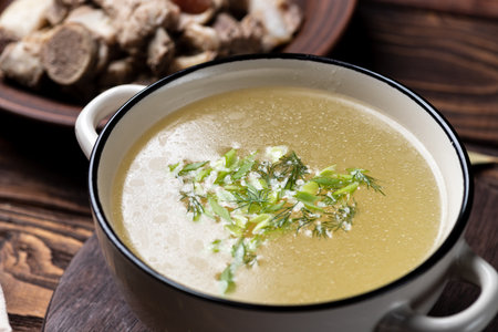 Creamy chicken soup with dill in a bowl on wooden backgroundの写真素材