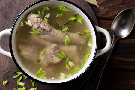 Chicken soup with dill and meatballs in a bowl on wooden backgroundの写真素材