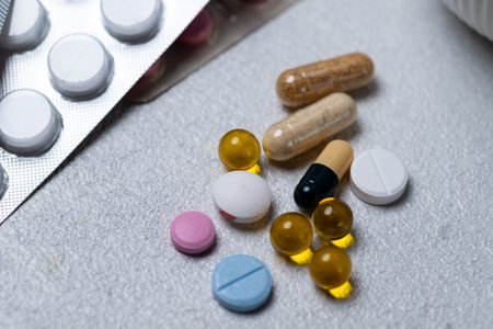 Tablets and capsules on a white tableの写真素材