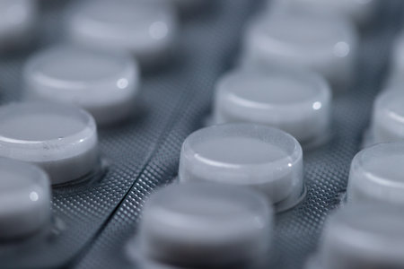 Tablets and capsules on a white tableの写真素材