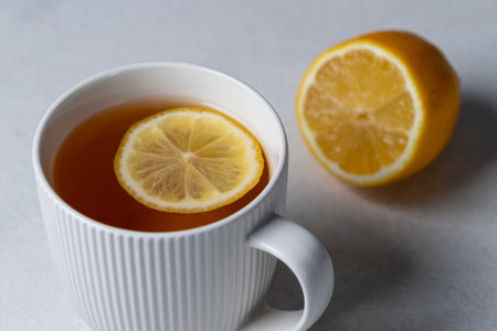 Tea with lemon in a white mugの写真素材
