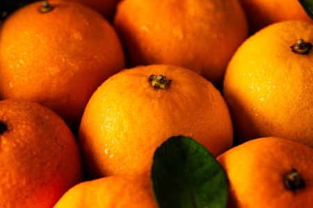 Tangerines in a plate on a wooden tableの写真素材