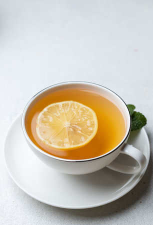 A cup of tea with lemon and ginger and mintの写真素材