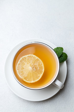 A cup of tea with lemon and ginger and mintの写真素材