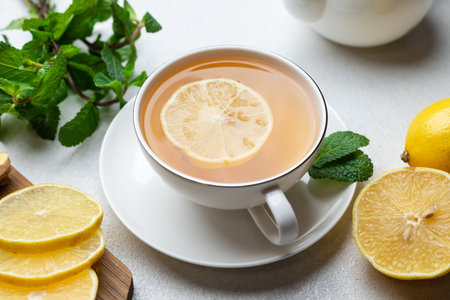 A cup of tea with lemon and ginger and mintの写真素材