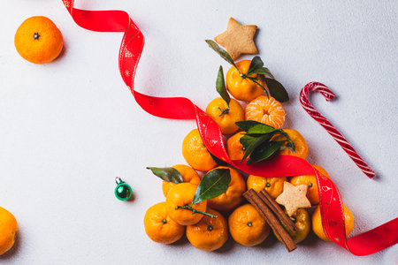 A Christmas tree lined with tangerines with leavesの写真素材