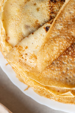 A stack of pancakes with a piece of melted butterの写真素材