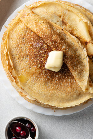 A stack of pancakes with a piece of melted butterの写真素材