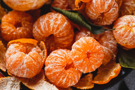 Tangerines with peeled skin on a plateの写真素材