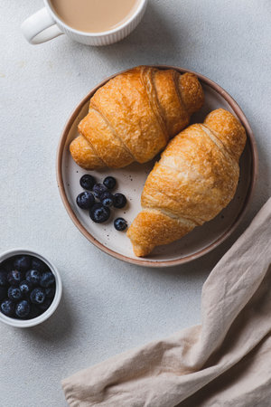 Croissants on a plate with blueberriesの写真素材