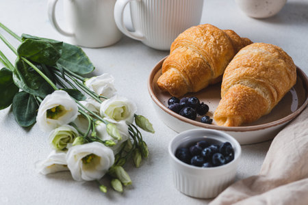 Croissants on a plate with blueberriesの写真素材