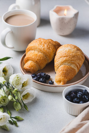 Croissants on a plate with blueberriesの写真素材