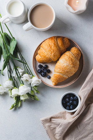 Croissants on a plate with blueberriesの写真素材