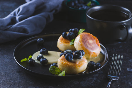 Cheesecakes served with berries and condensed milkの写真素材
