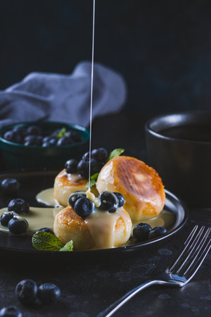 Cheesecakes served with berries and condensed milkの写真素材