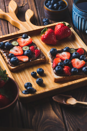 Sandwich with chocolate paste and strawberries and blueberries