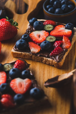 Sandwich with chocolate paste and strawberries and blueberries