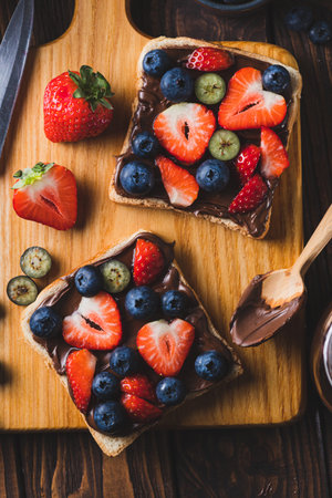 Sandwich with chocolate paste and strawberries and blueberriesの写真素材