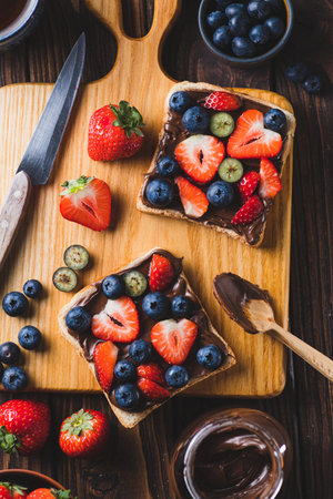 Sandwich with chocolate paste and strawberries and blueberriesの写真素材