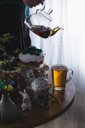Easter cakes on the table with poured teaの写真素材
