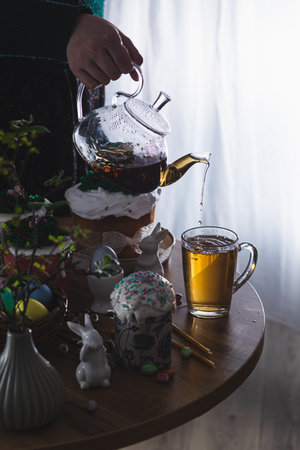 Easter cakes on the table with poured teaの写真素材