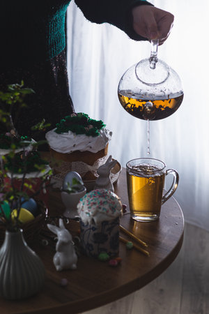 Easter cakes on the table with poured teaの写真素材