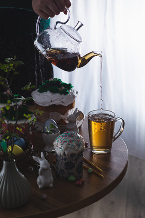 Easter cakes on the table with poured teaの写真素材