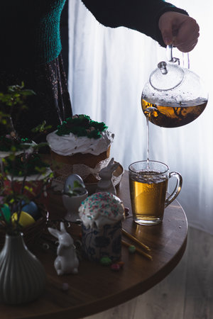 Easter cakes on the table with poured teaの写真素材