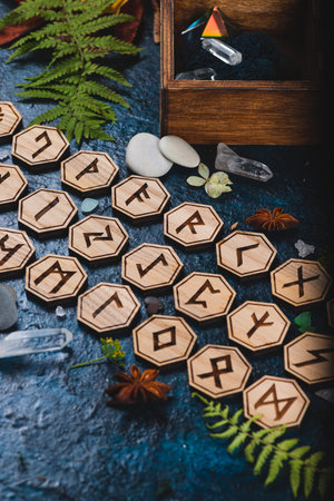 Wooden runes are lying on the table among various objects. Astrology and esotericism. Senior Futhar