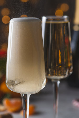 Champagne is poured into a glass from a bottleの写真素材