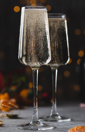 Champagne is poured into a glass from a bottleの写真素材