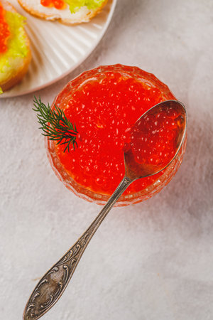 Red caviar in a caviar dish with a sprig of dillの写真素材