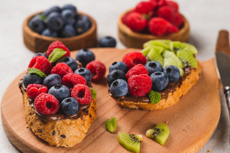 Sandwiches with chocolate paste, raspberries and blueberriesの写真素材