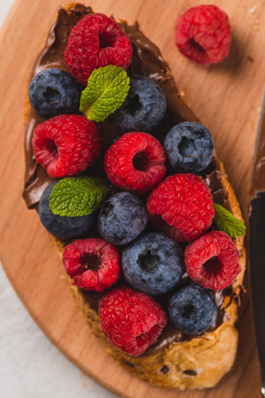 Sandwiches with chocolate paste, raspberries and blueberriesの写真素材