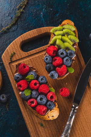 Sandwiches with chocolate paste, raspberries and blueberriesの写真素材