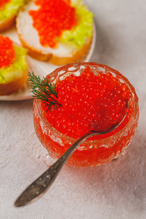 Red caviar in a caviar dish with a sprig of dillの写真素材