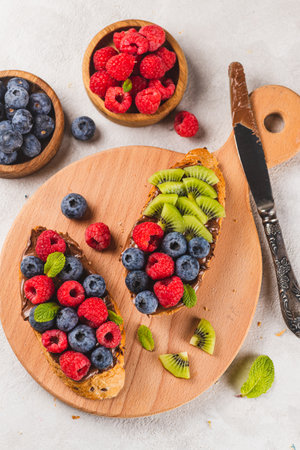 Sandwiches with chocolate paste, raspberries and blueberriesの写真素材